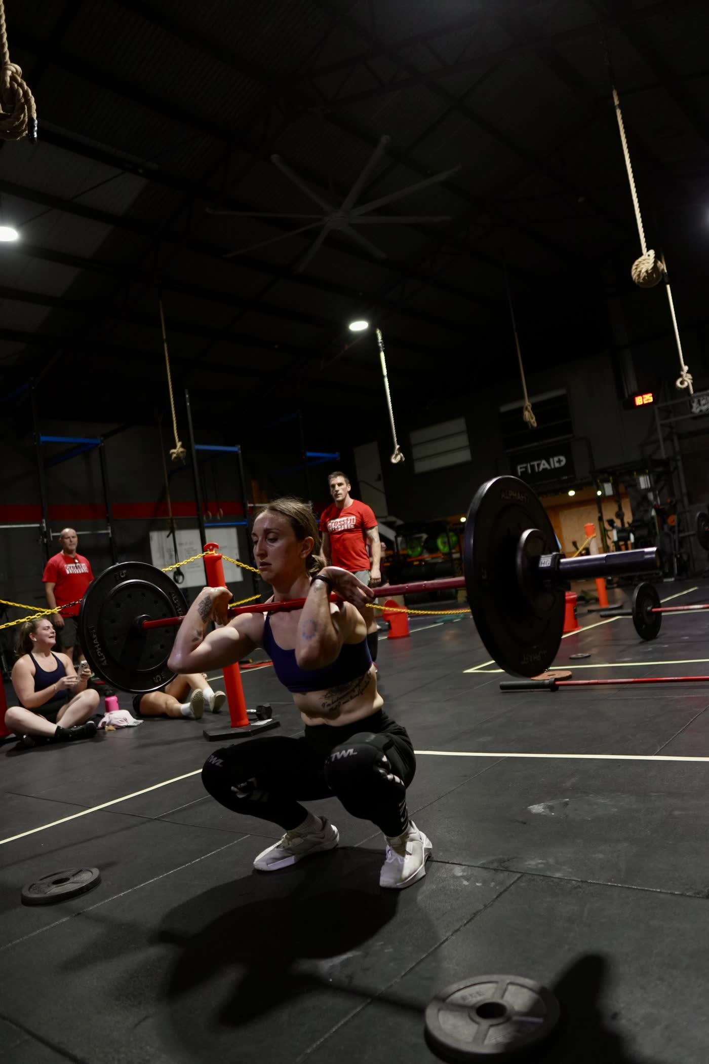 CrossFit Brisbane athlete receiving a barbell in a front squat during weightlifting
